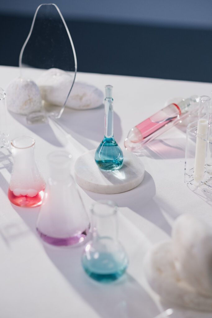 K-Beauty's Fermented Skincare Trend: What the Research Actually Says About Your Skin Barrier. Laboratory beakers showing fermented skincare ingredients in blue and pink solutions